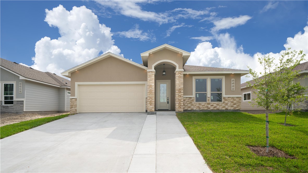 a front view of a house with a yard and garage