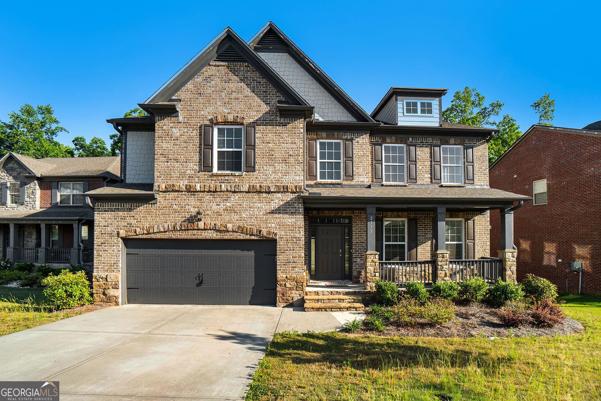 a front view of a house with yard and furniture