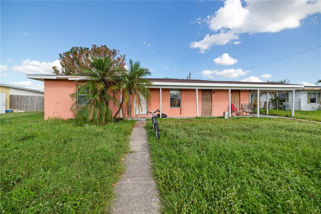 a front view of house with yard and green space