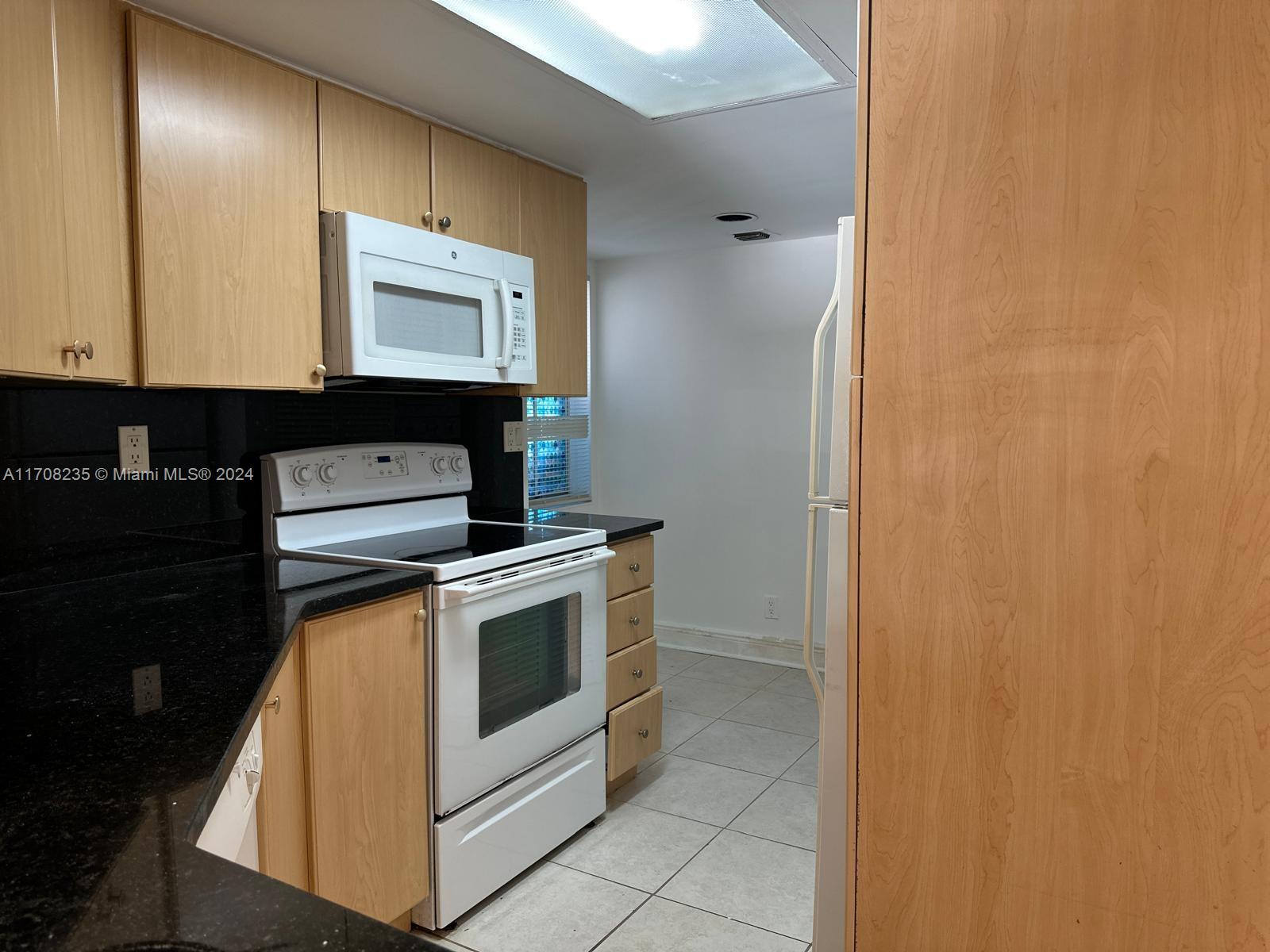 a kitchen with a stove and a microwave