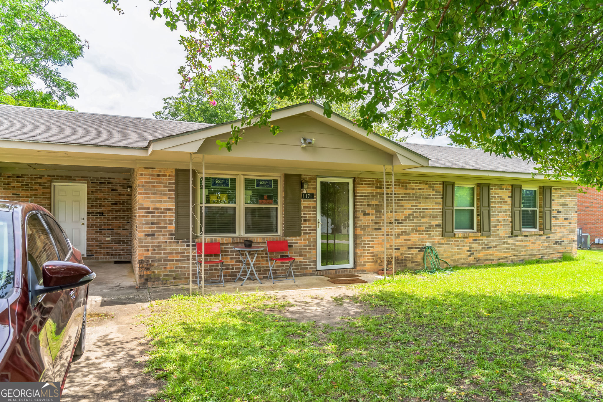 a front view of house with yard outdoor seating and barbeque oven