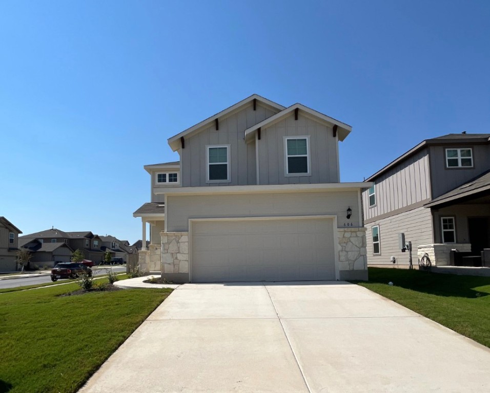 a front view of a house with a yard and garage