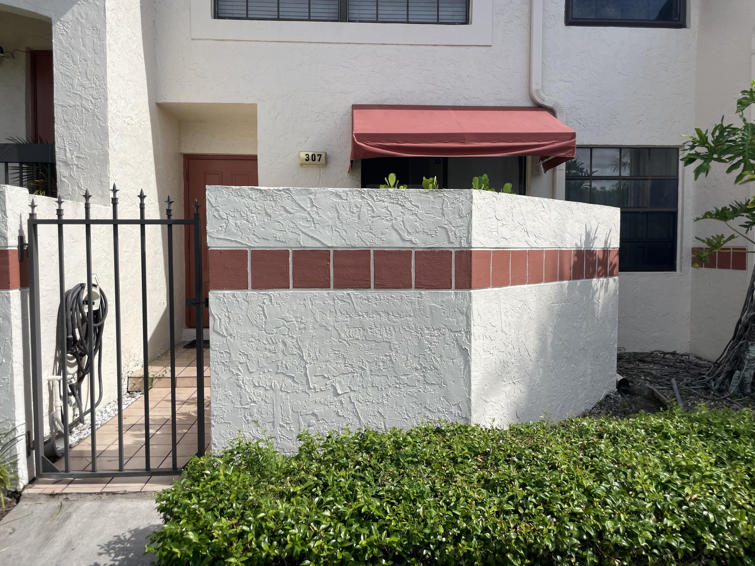 a backyard of a house with table and chairs