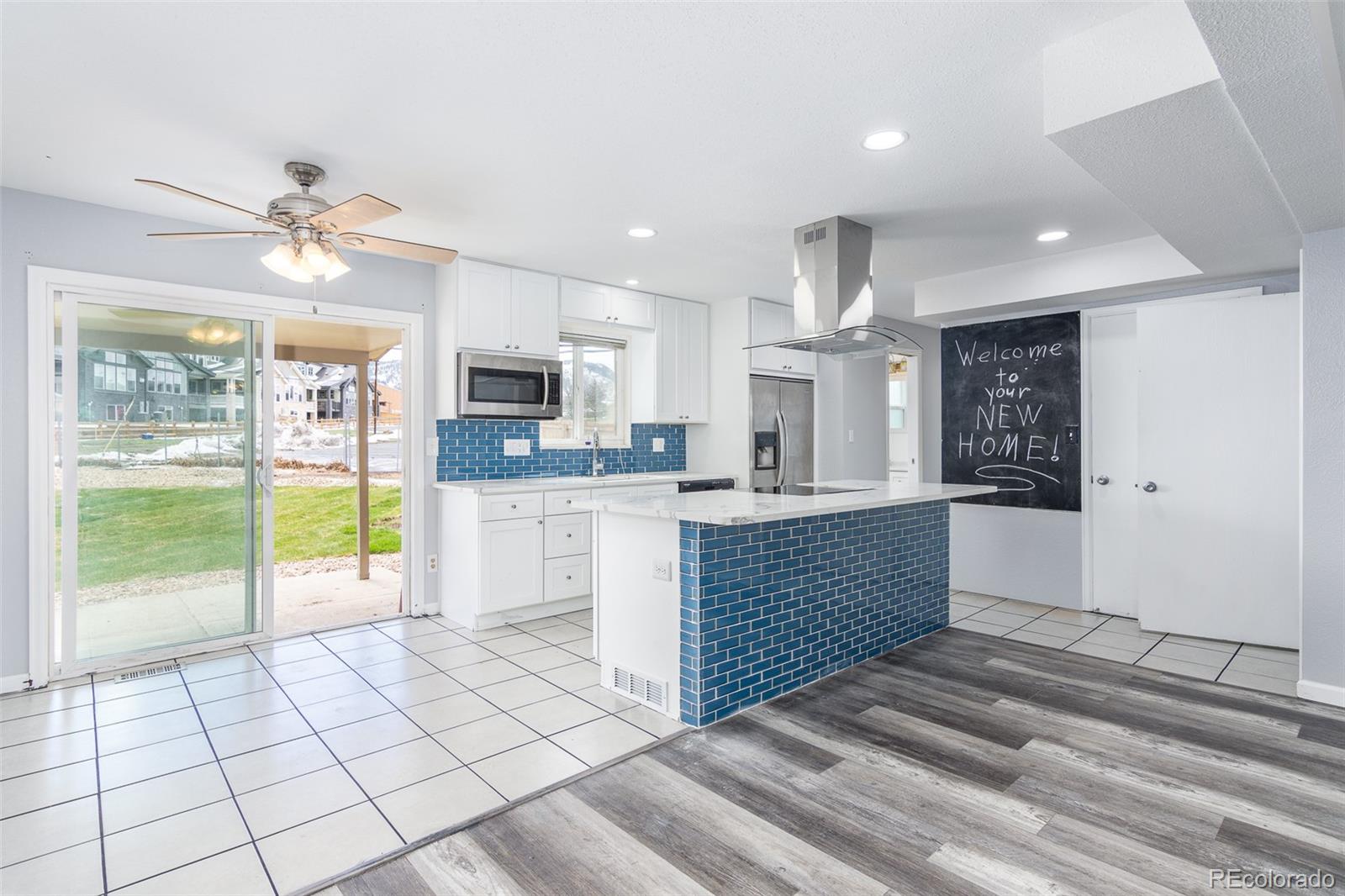 a large kitchen with kitchen island granite countertop a large counter top and appliances