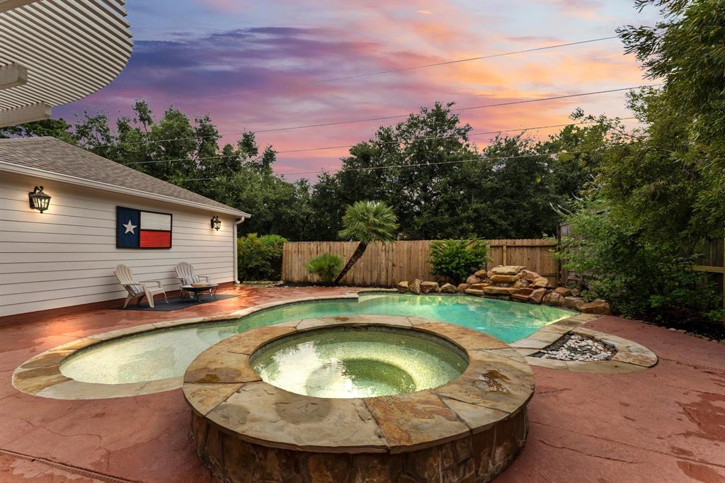 a view of a swimming pool with sitting area