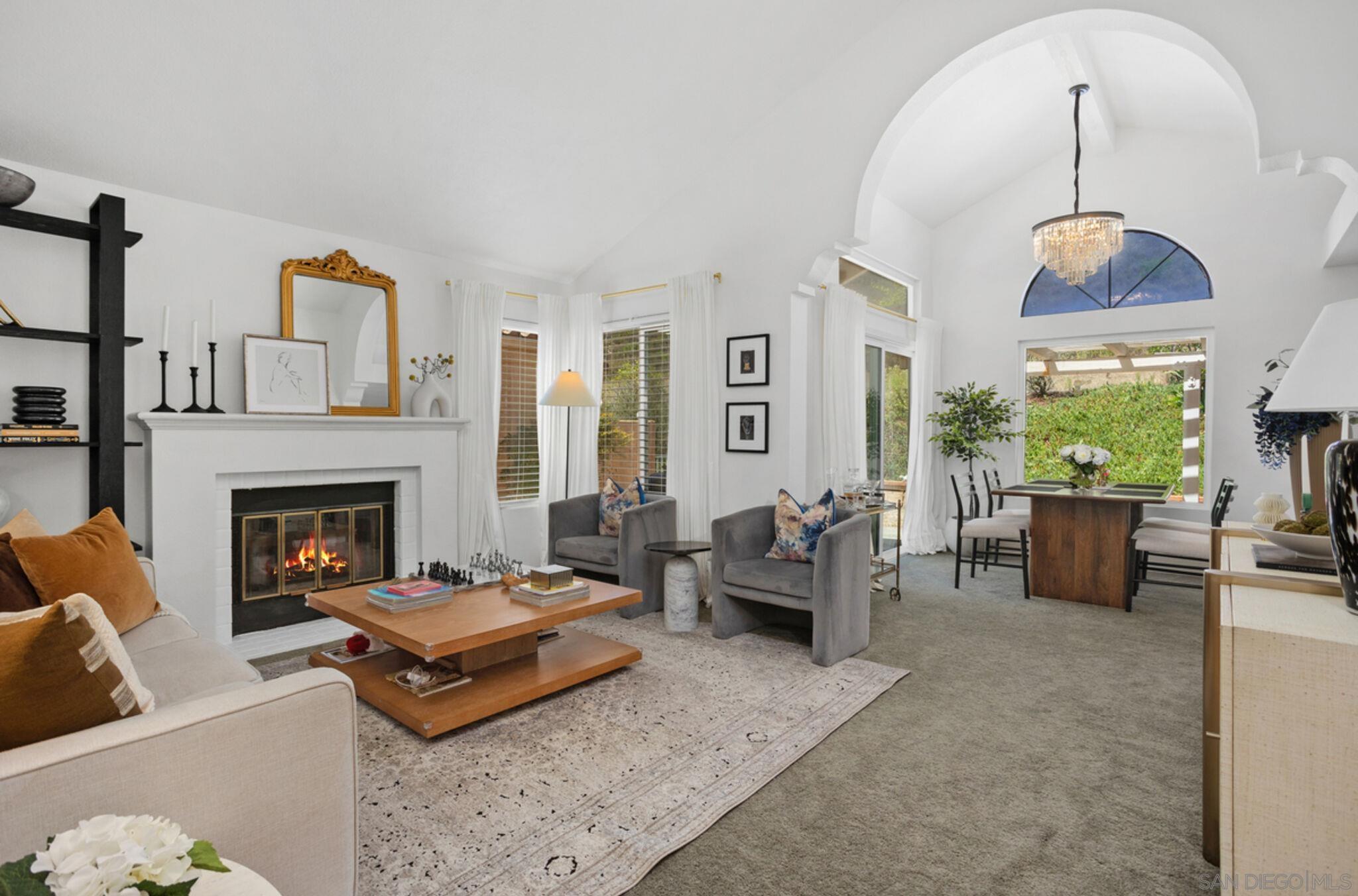 a living room with furniture fireplace and window