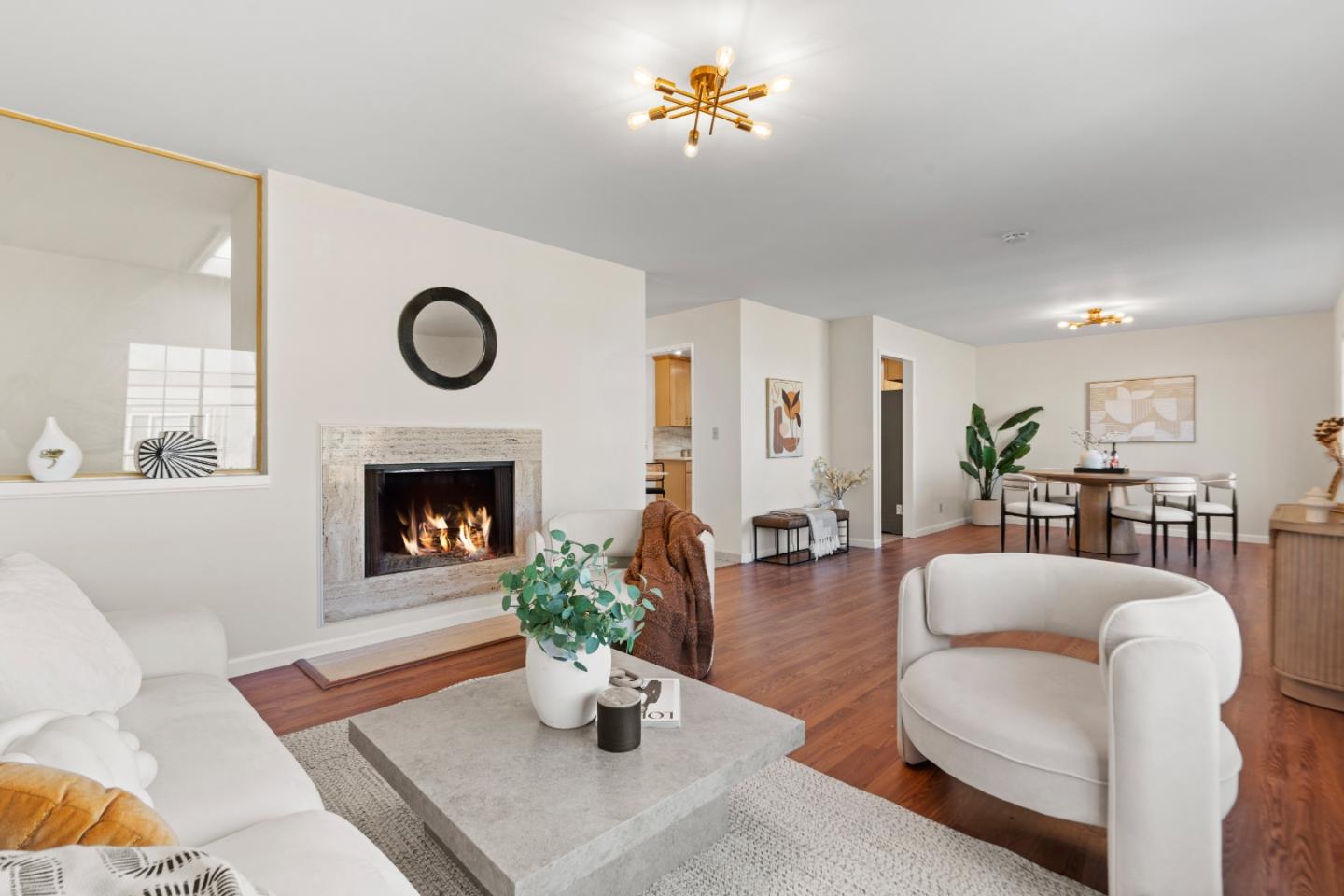 a living room with furniture a fireplace and a clock