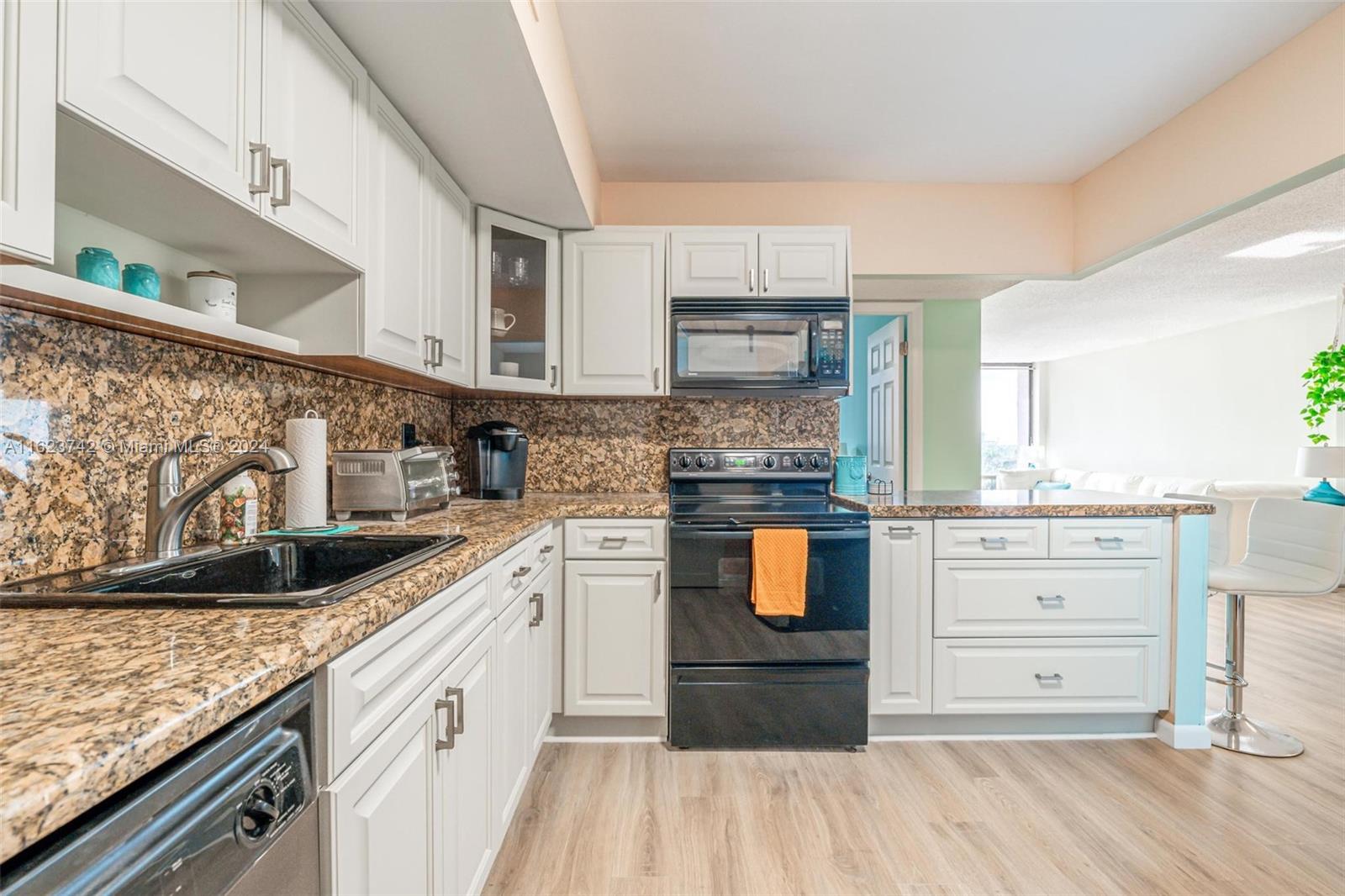 a kitchen with granite countertop a sink and cabinets