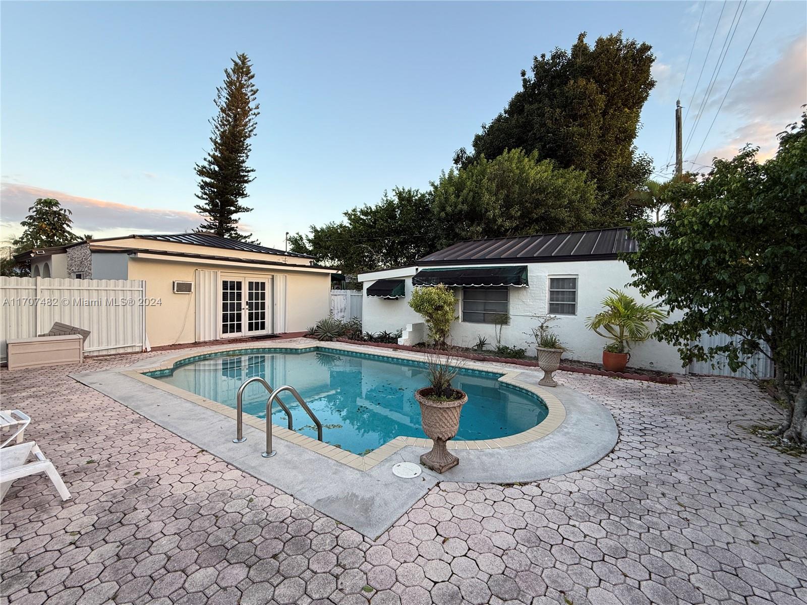 a view of house with swimming pool outdoor seating