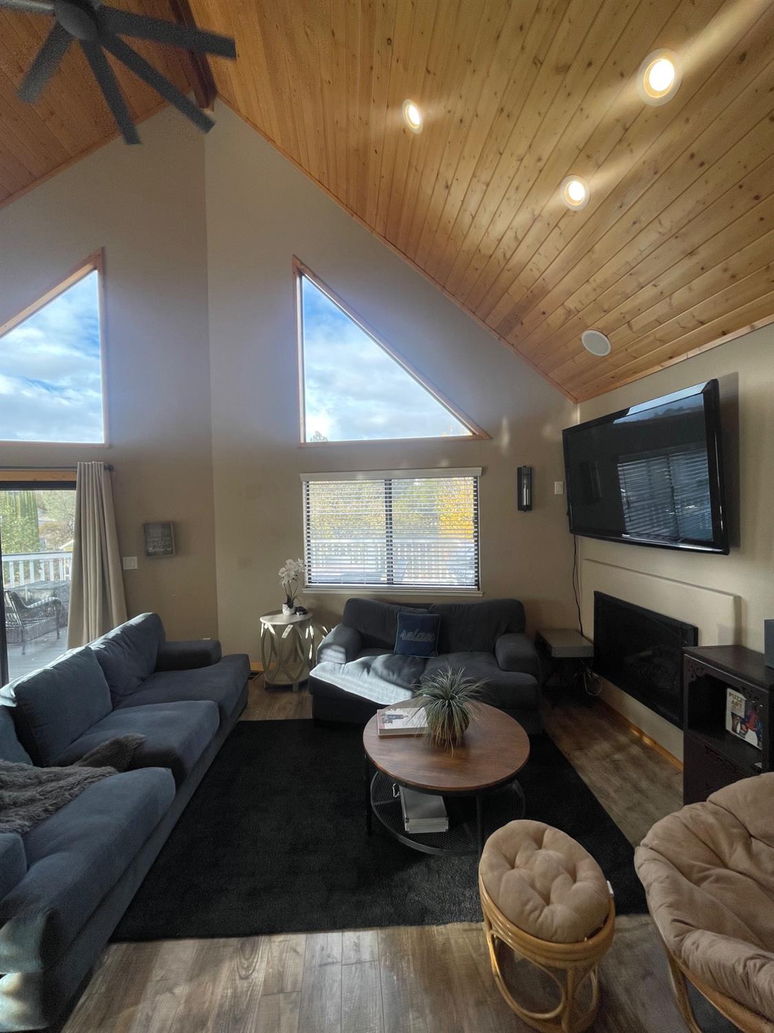 a living room with furniture kitchen view and a window