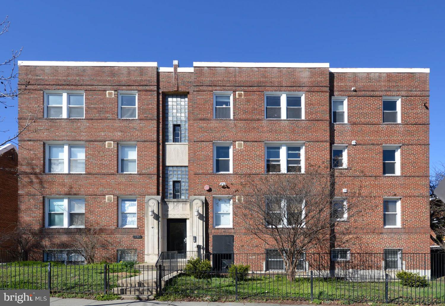 a front view of a building with garden