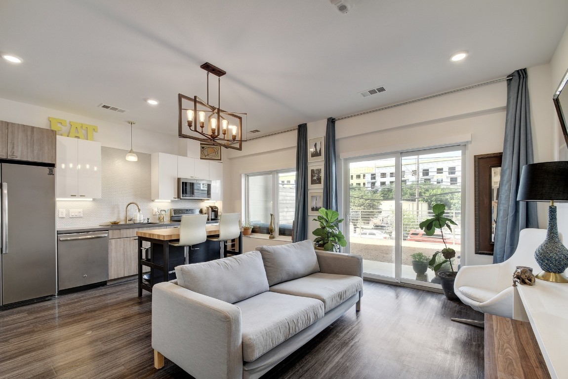 a living room with kitchen island furniture and a large window