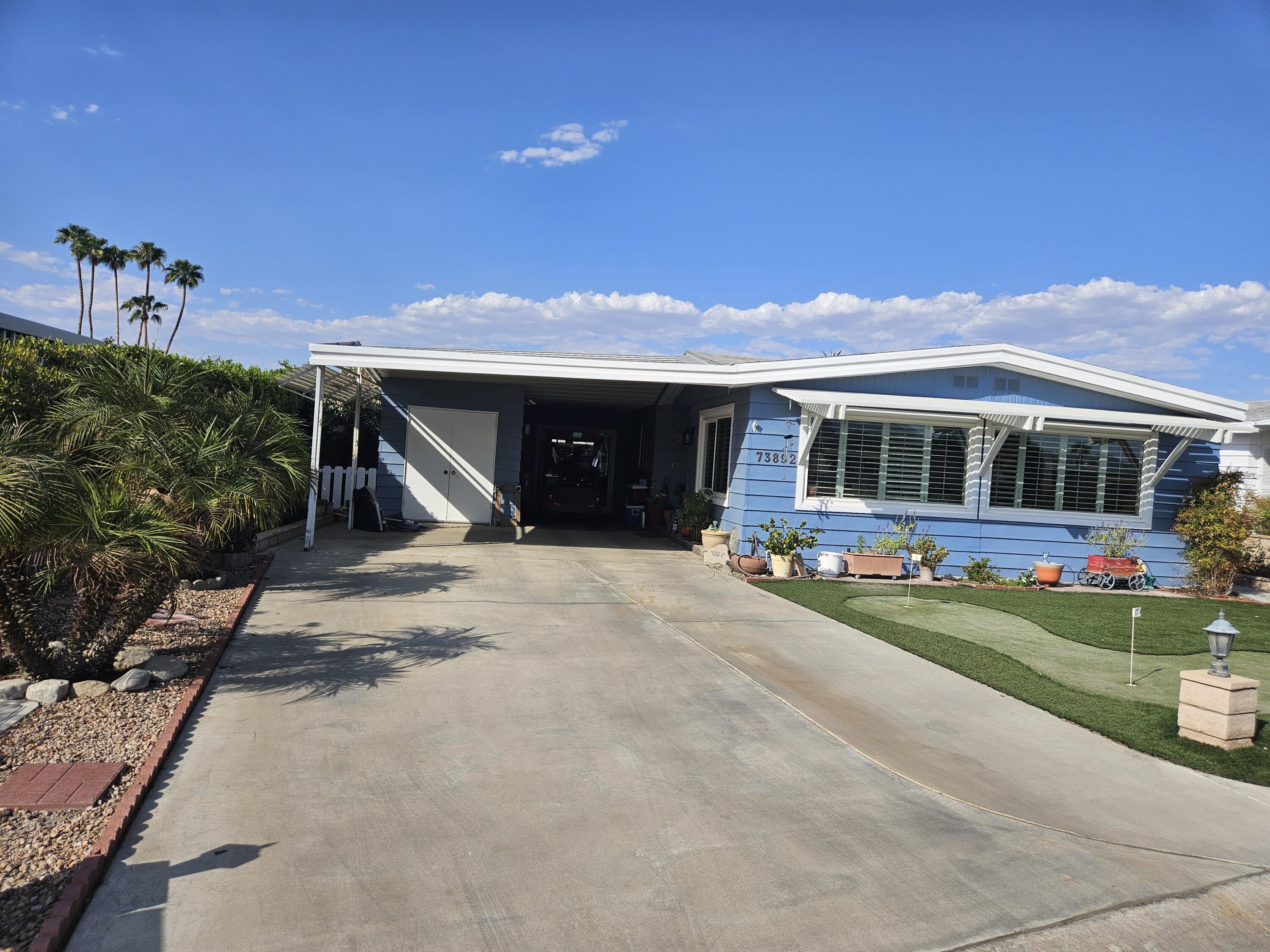 a view of a house with backyard porch and sitting area