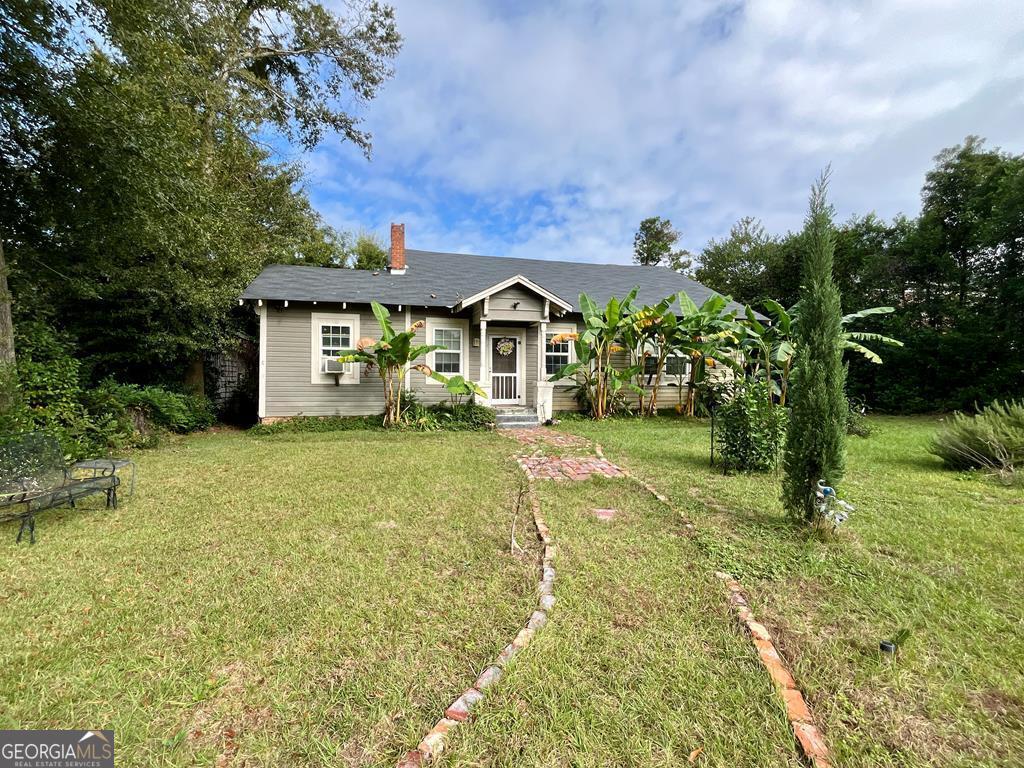 a front view of a house with garden