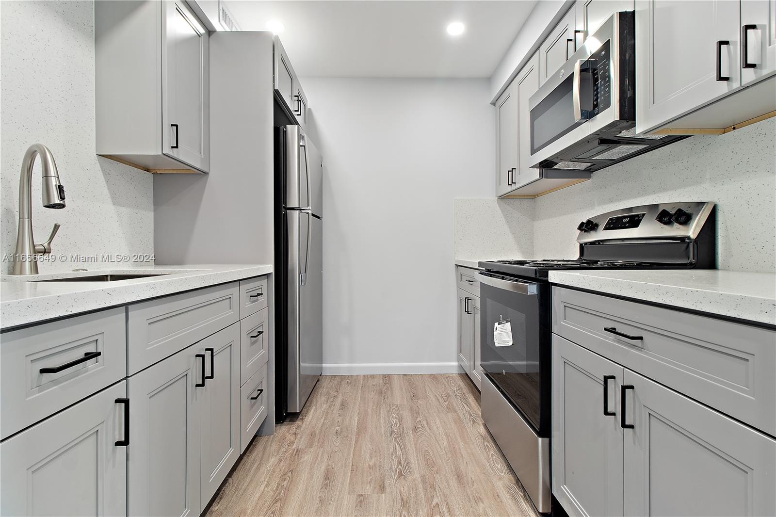 a kitchen with stainless steel appliances granite countertop a stove and a refrigerator