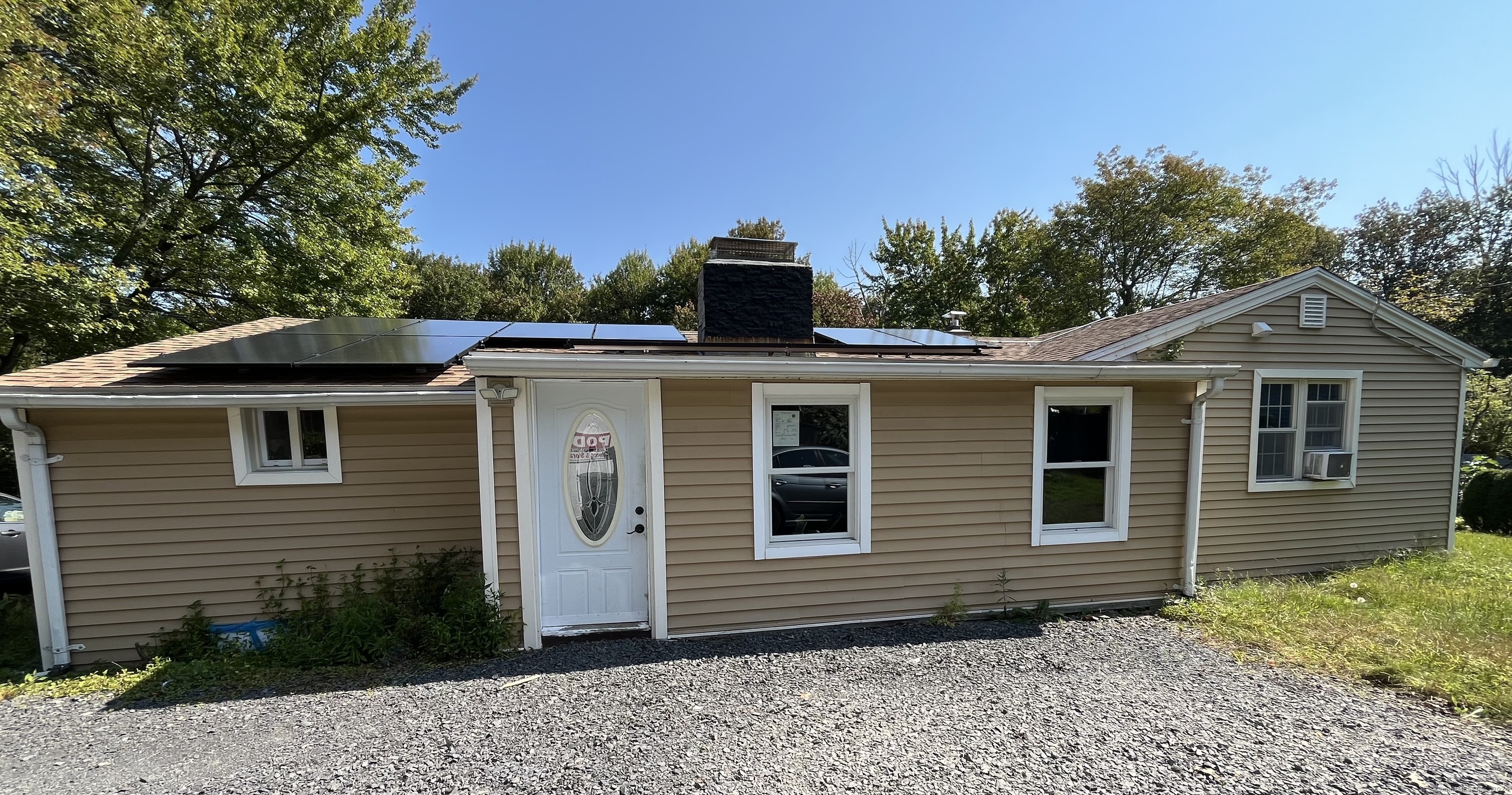 a front view of a house with a garden