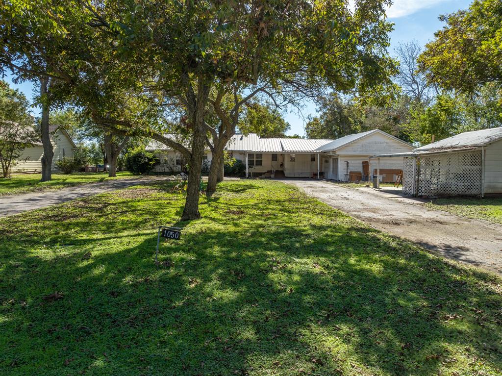 a house with a big yard and large trees