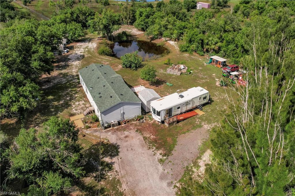 Birds eye view of property with a water view