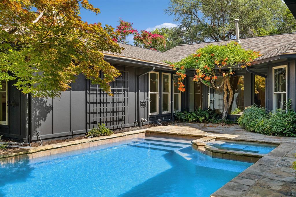 a view of a house with swimming pool and sitting area