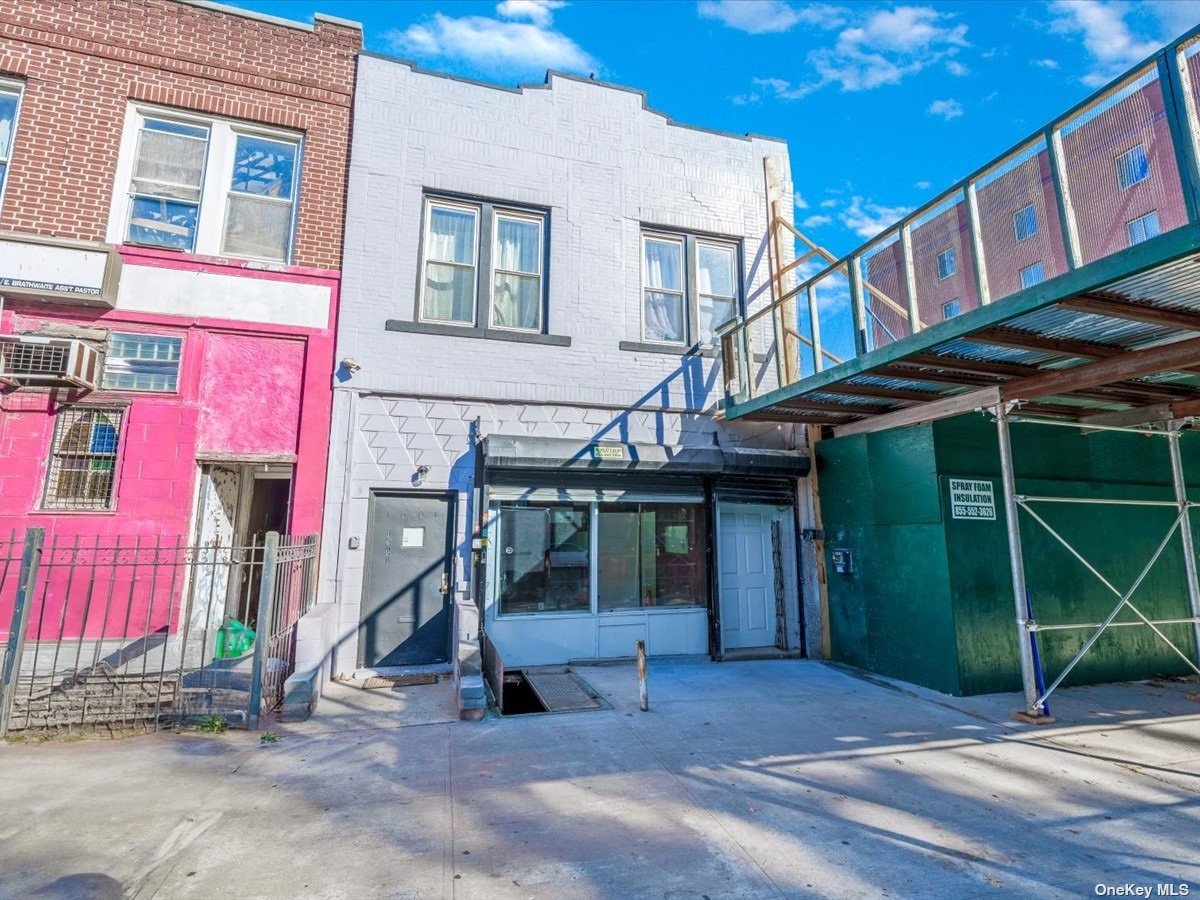 a view of a house with a patio and a yard