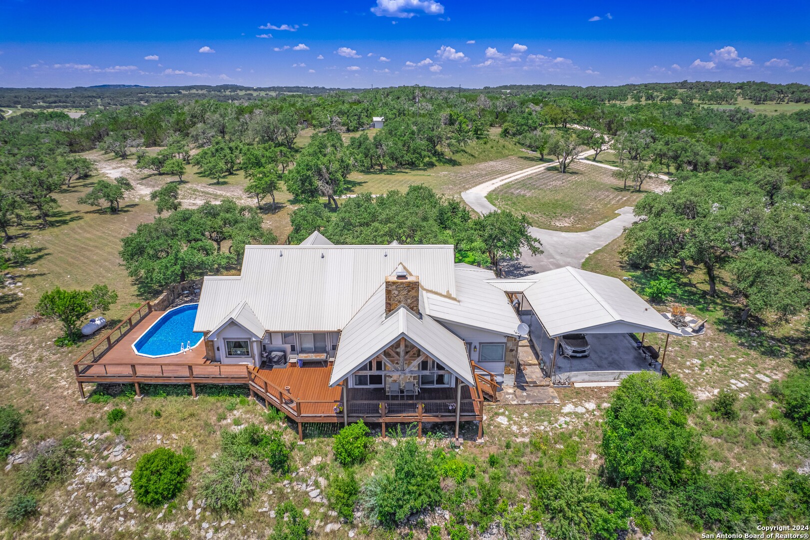 an aerial view of a house with a garden and swimming pool