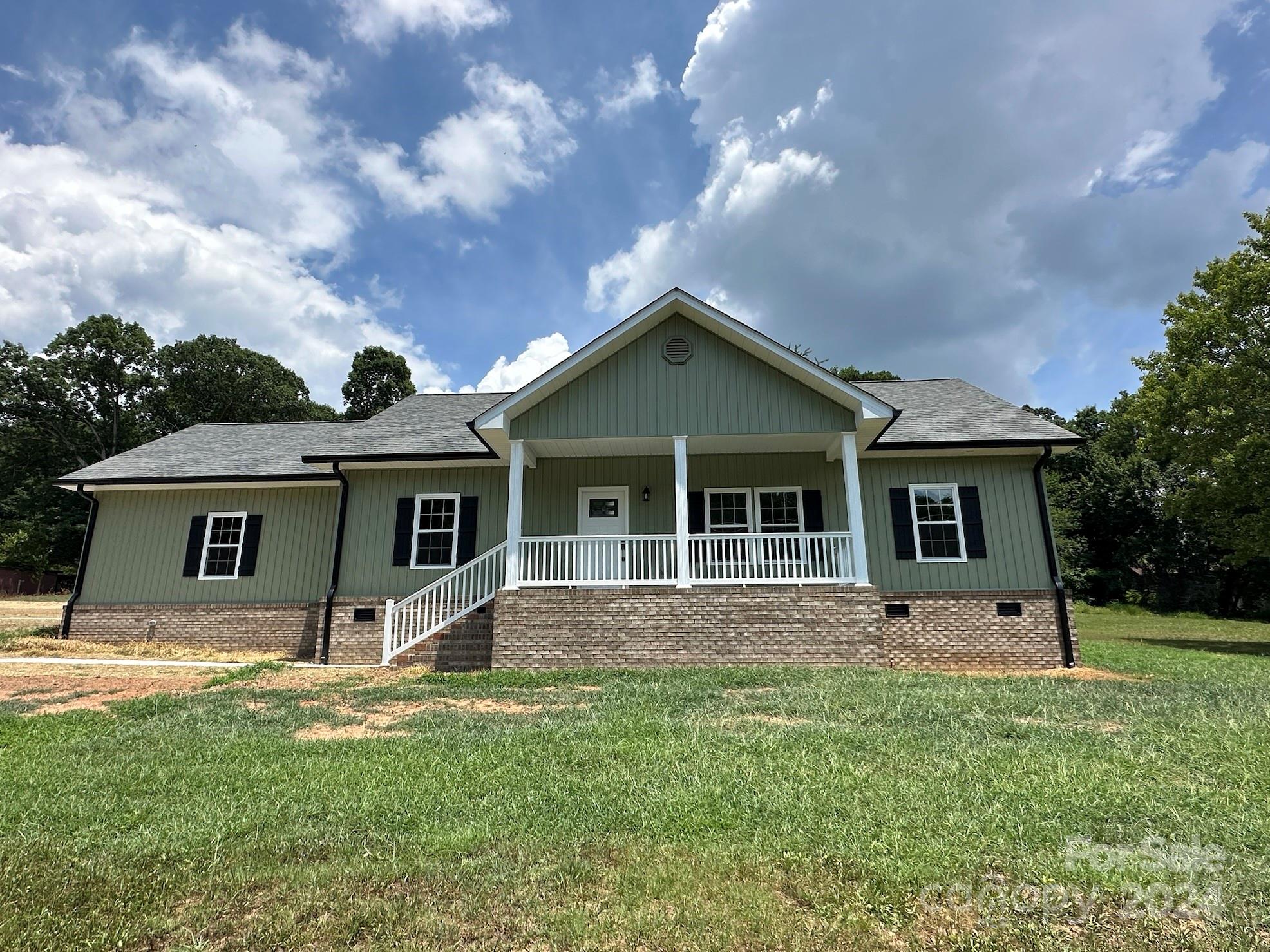 a front view of house with yard and green space