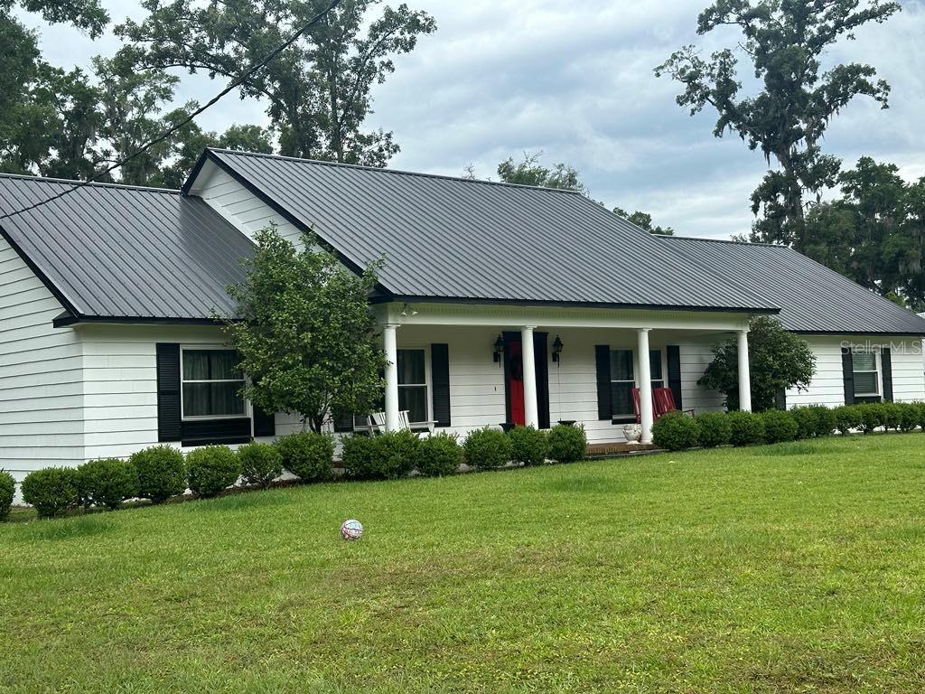 a front view of a house with garden