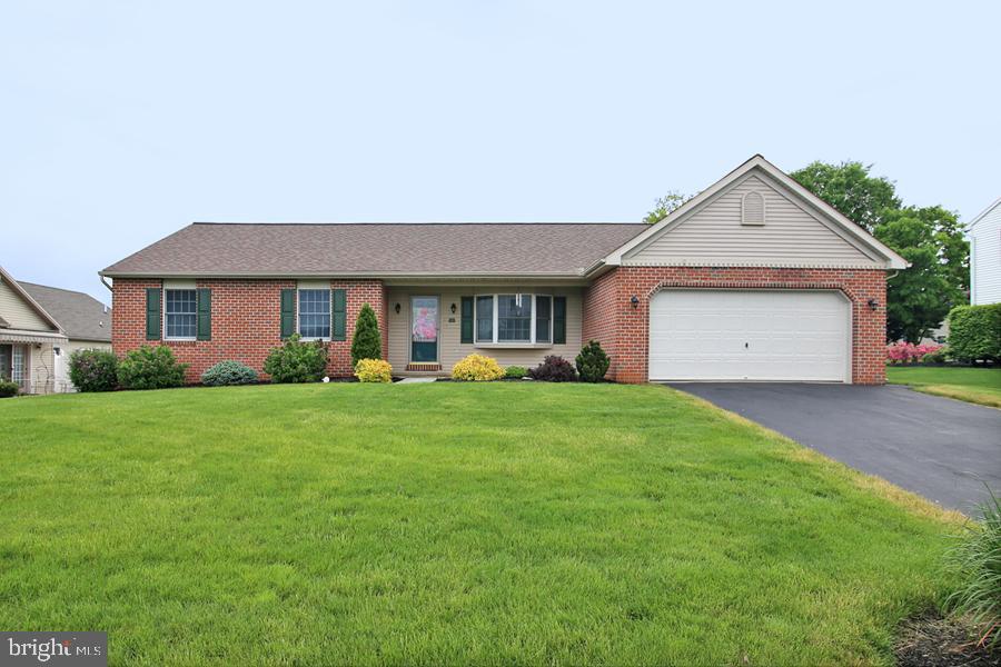 a front view of house with yard and green space