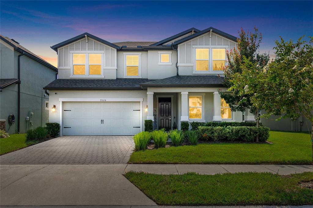 a front view of a house with a yard and garage