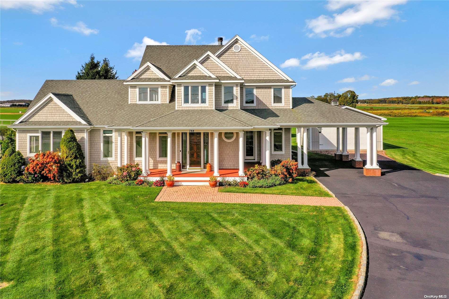 a front view of a house with swimming pool having outdoor seating