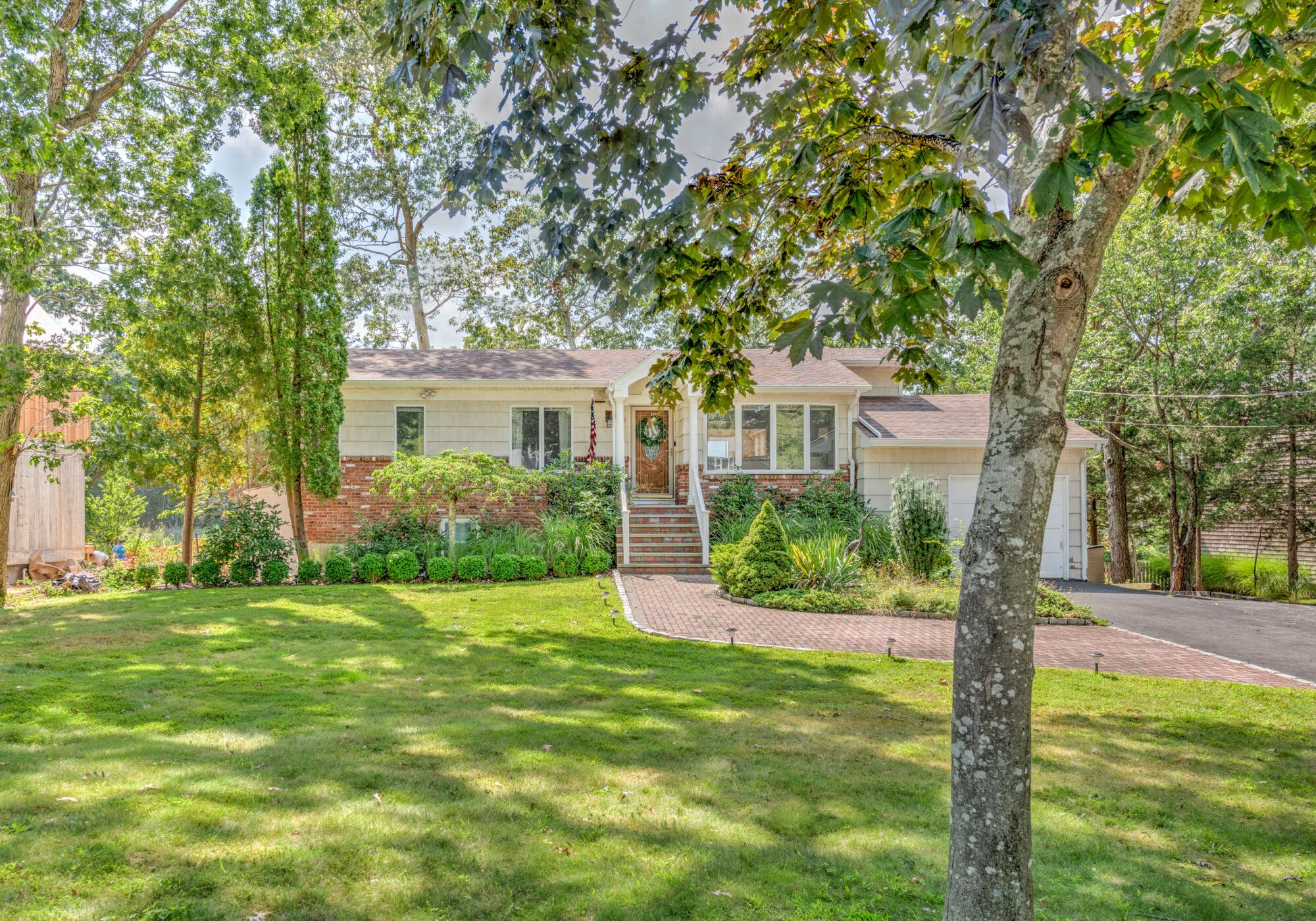 a front view of a house with garden