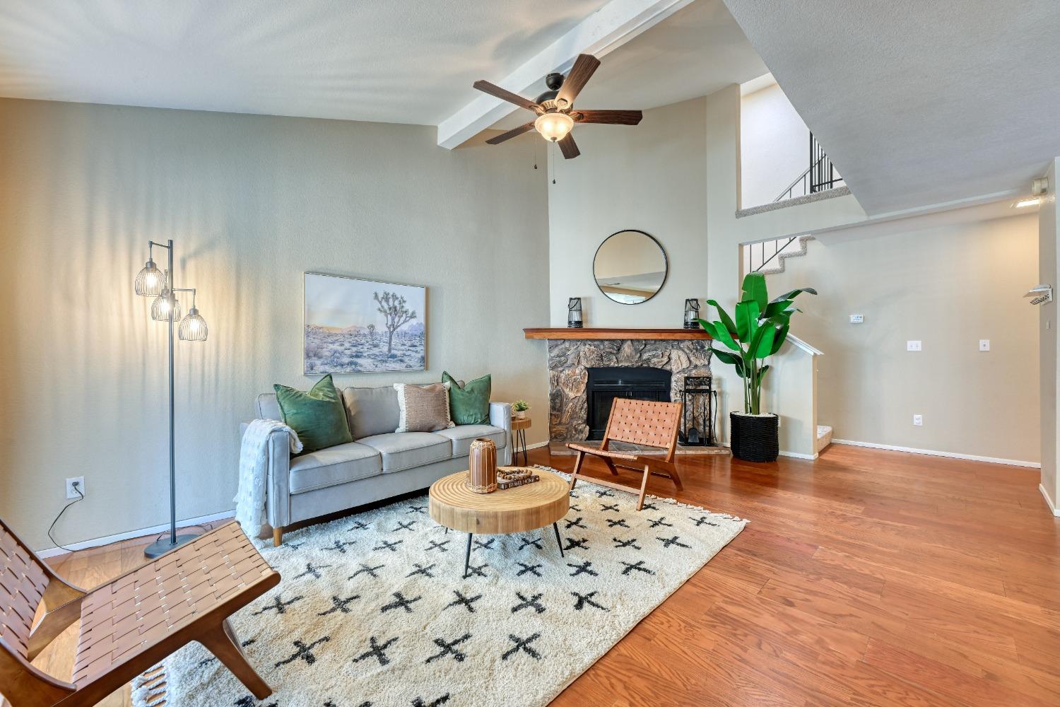 a living room with furniture a fireplace and a potted plant