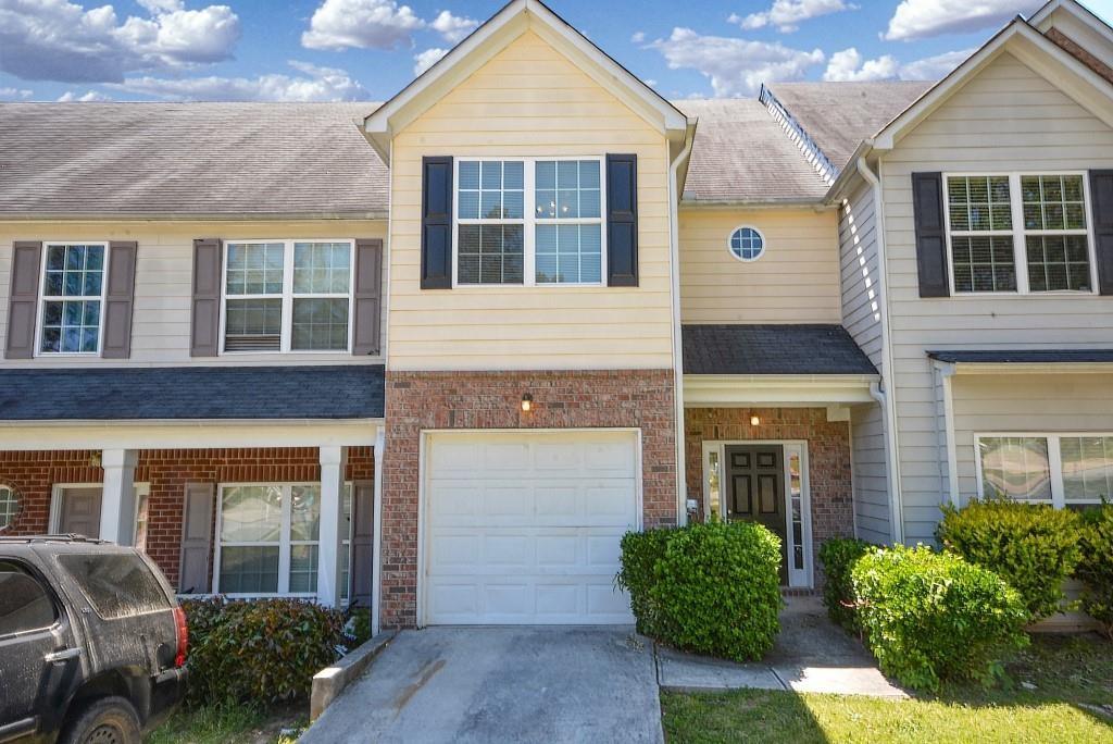 front view of a brick house with a yard