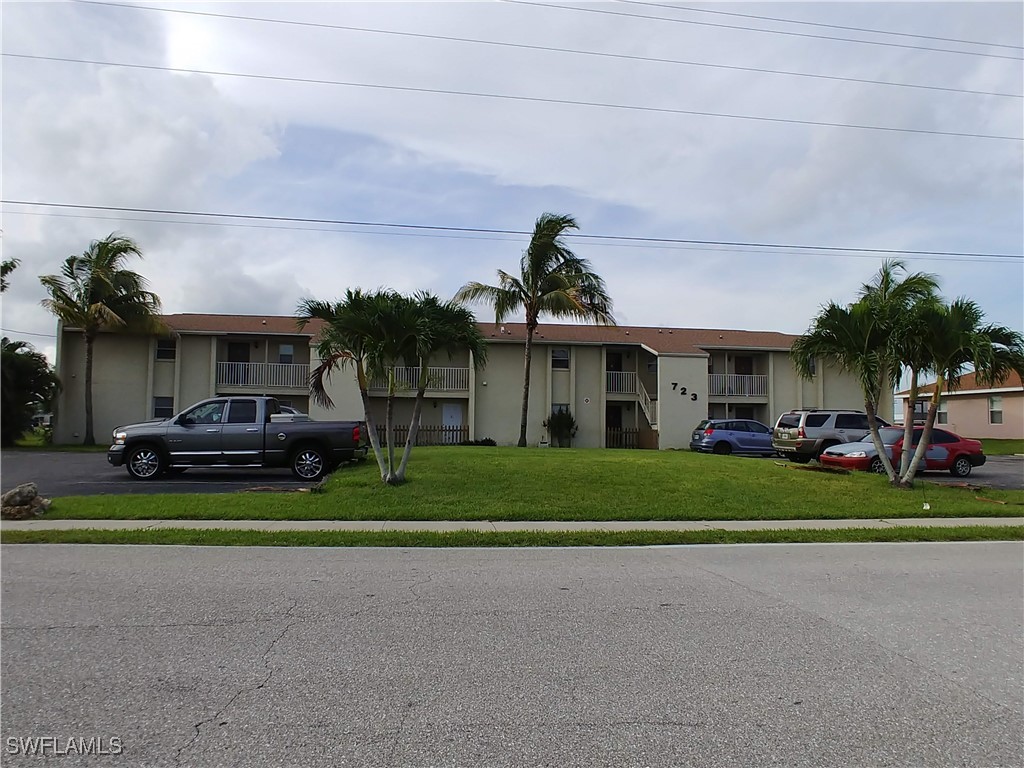 a front view of house with outdoor space and car parked