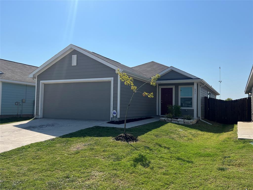 a front view of a house with a yard