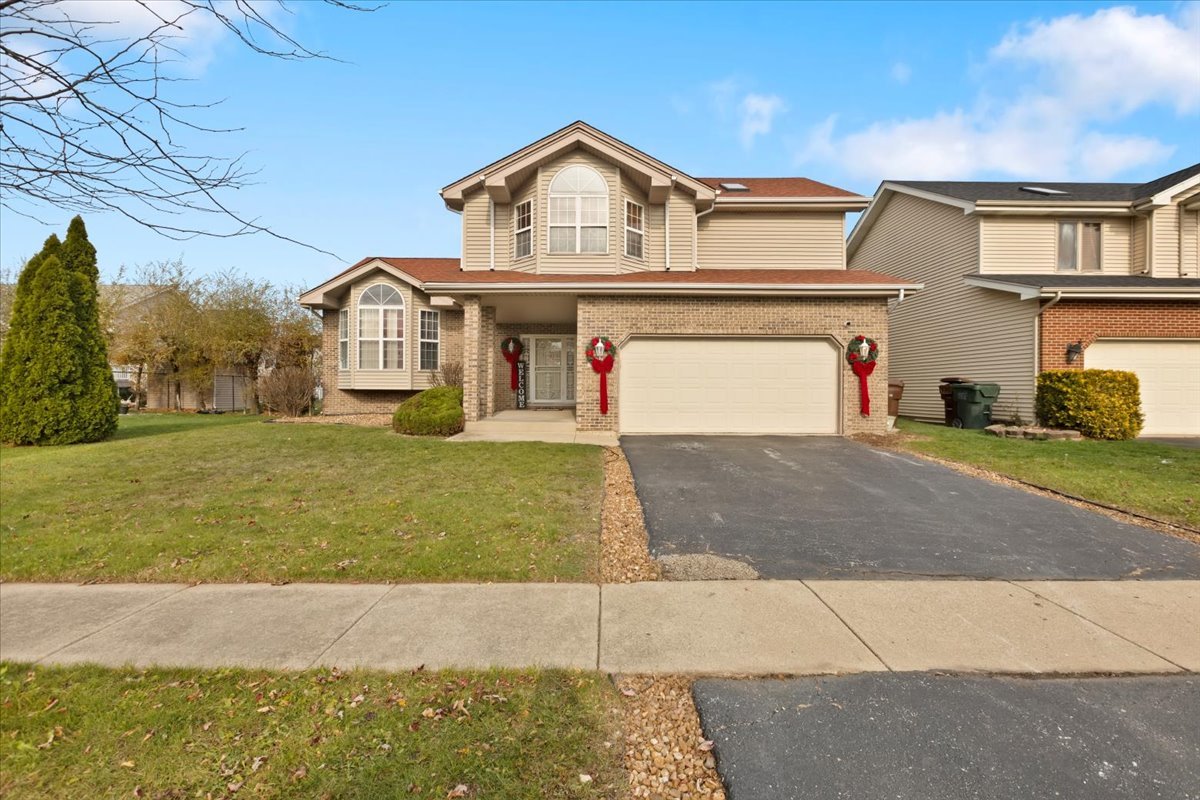 a front view of a house with a yard and garage