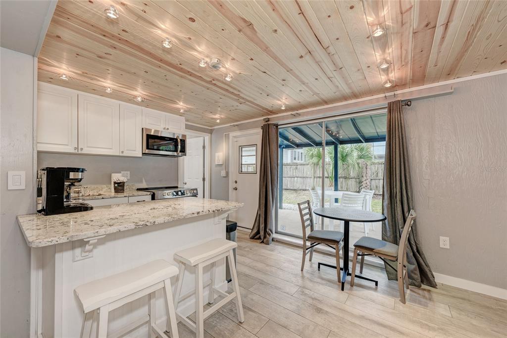 a kitchen with a sink appliances cabinets and furniture