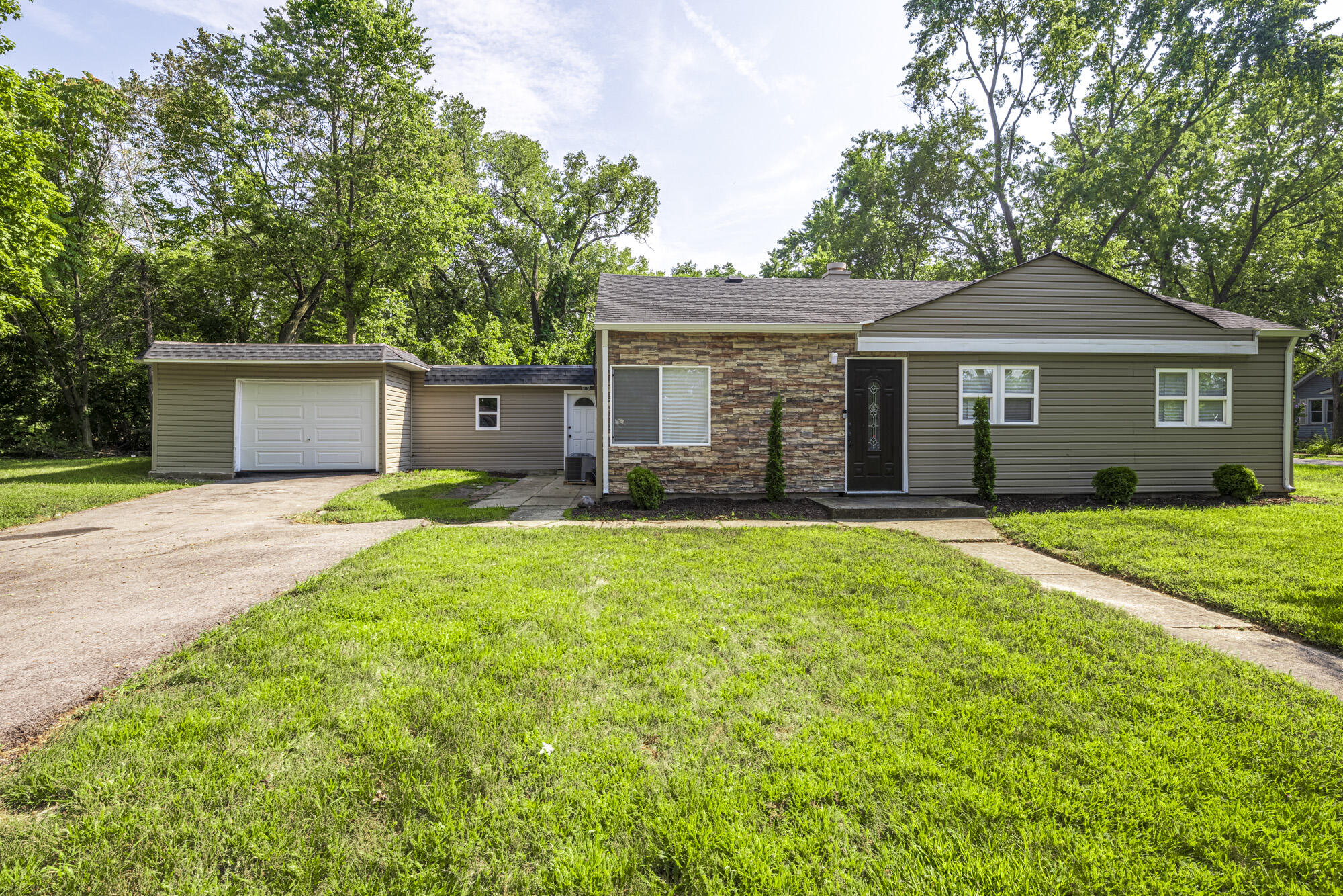 a front view of a house with a garden and yard