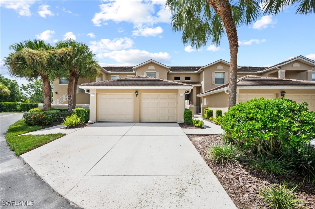 a front view of a house with a yard and palm tree