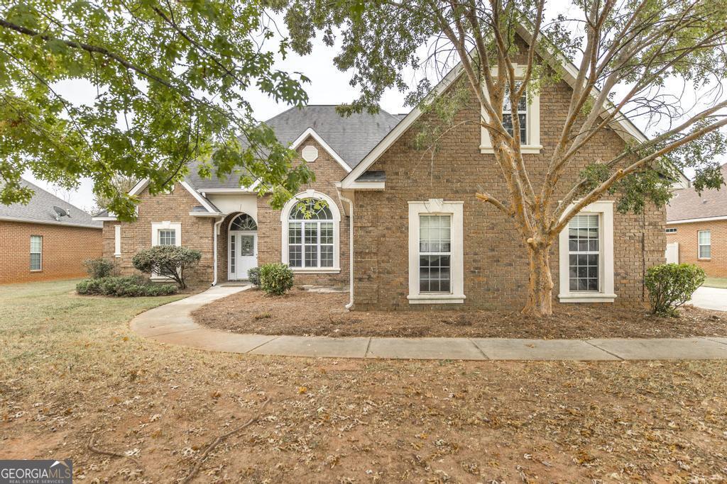 a front view of a house with a yard