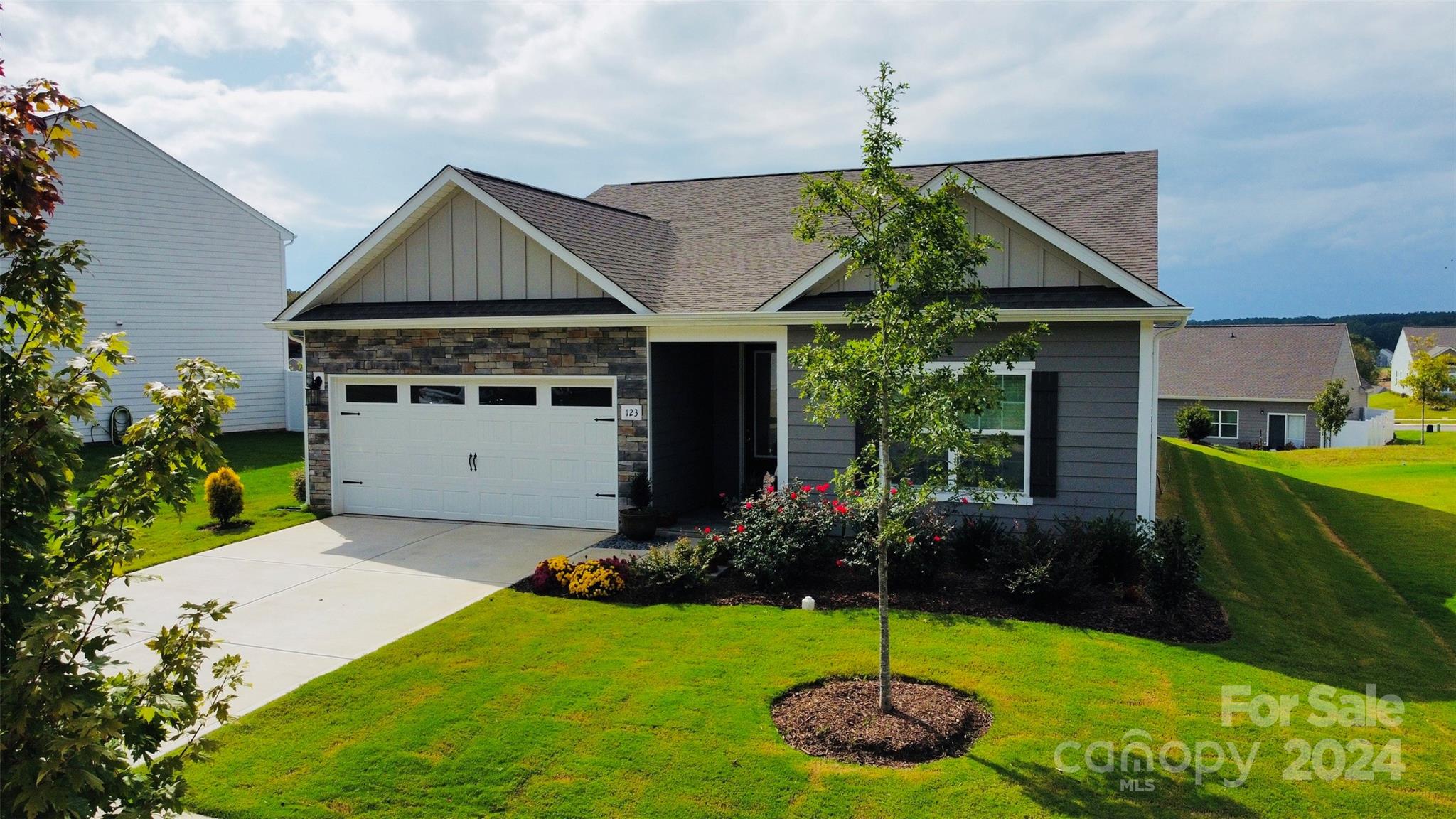 a front view of a house with a yard and garage