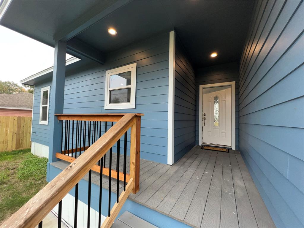 a view of balcony with wooden floor and fence