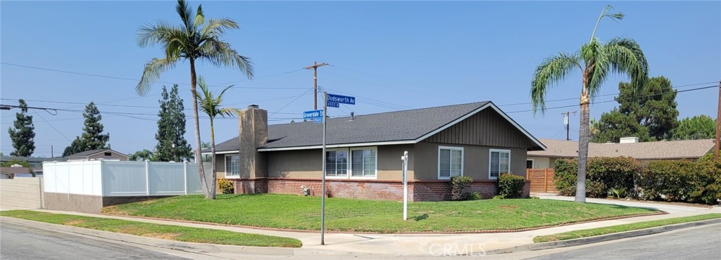 a front view of a house with a garden and yard