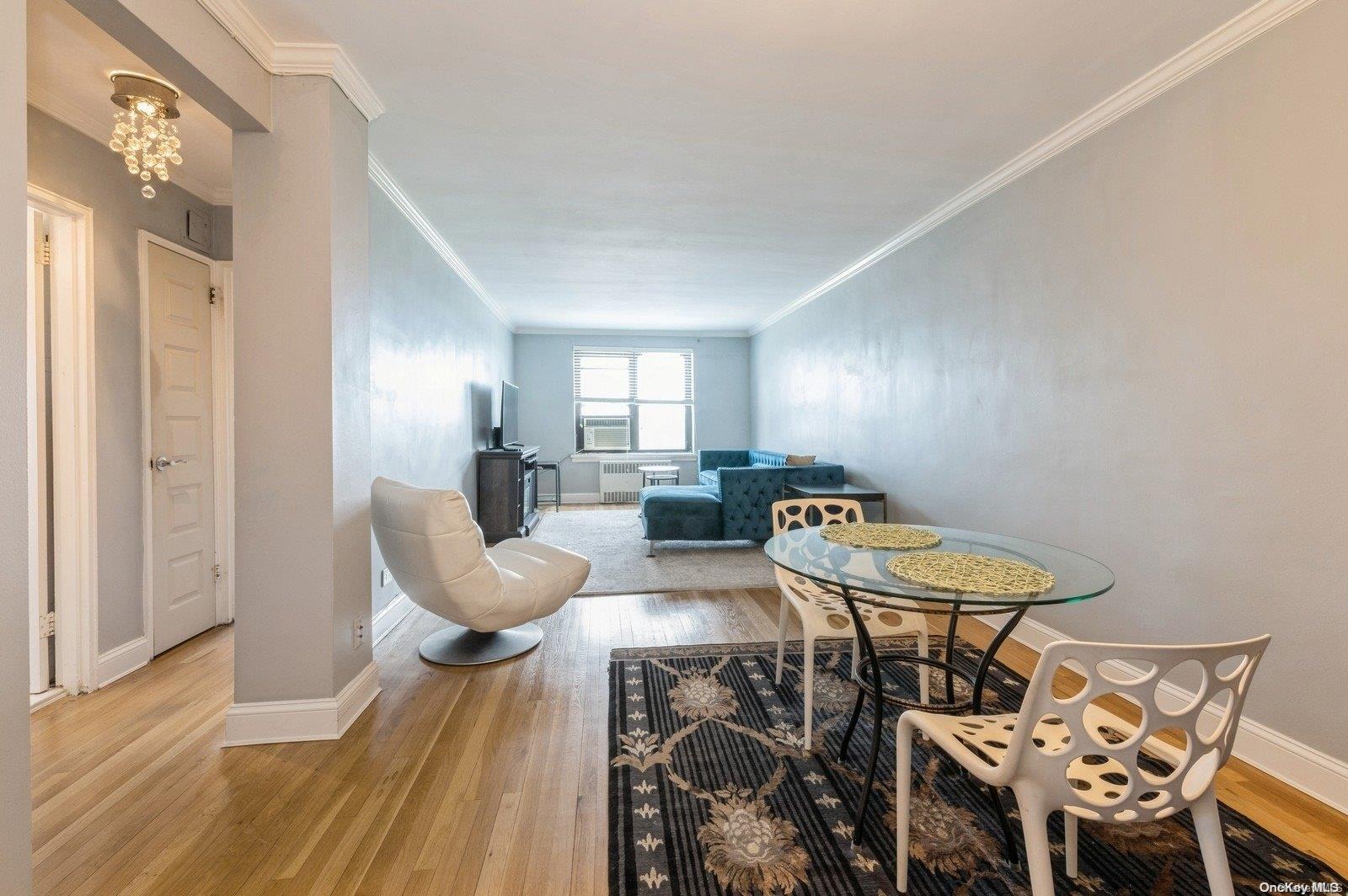 a dining room with furniture and wooden floor