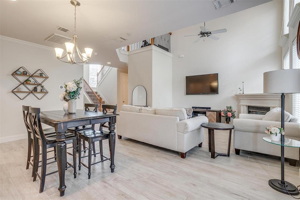 a dining room with furniture a chandelier and wooden floor