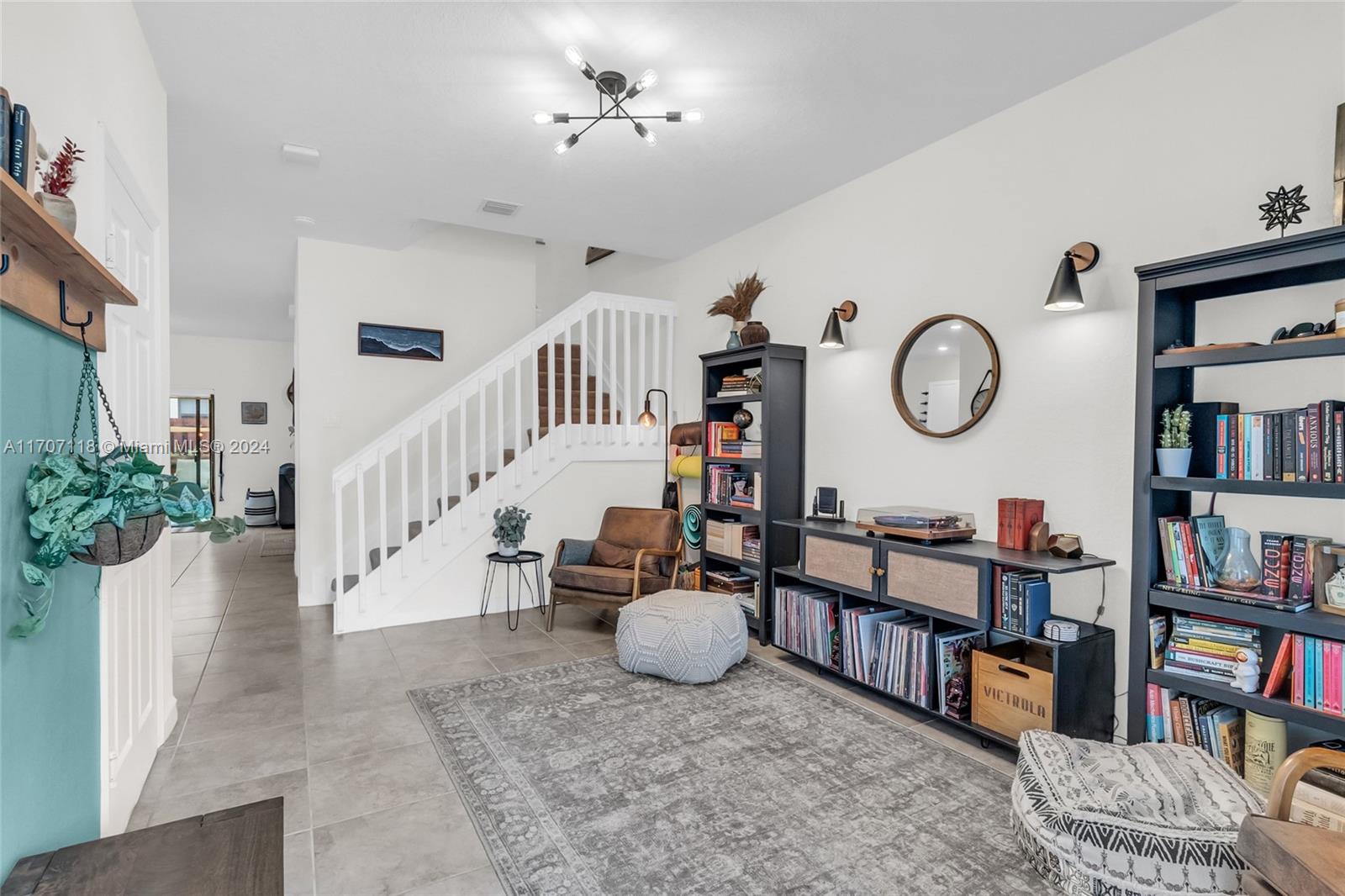 a living room with furniture and a book shelf