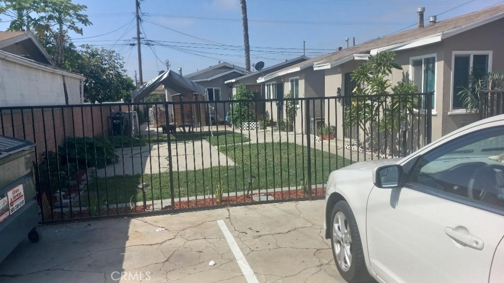 a view of a house with a wooden fence