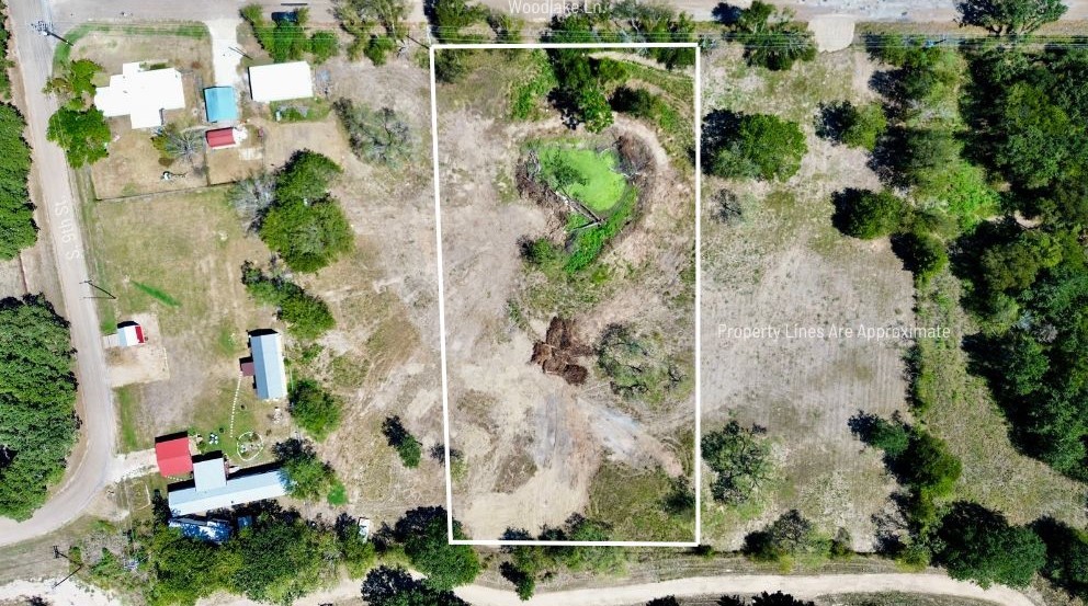 an aerial view of a house with a yard and garden