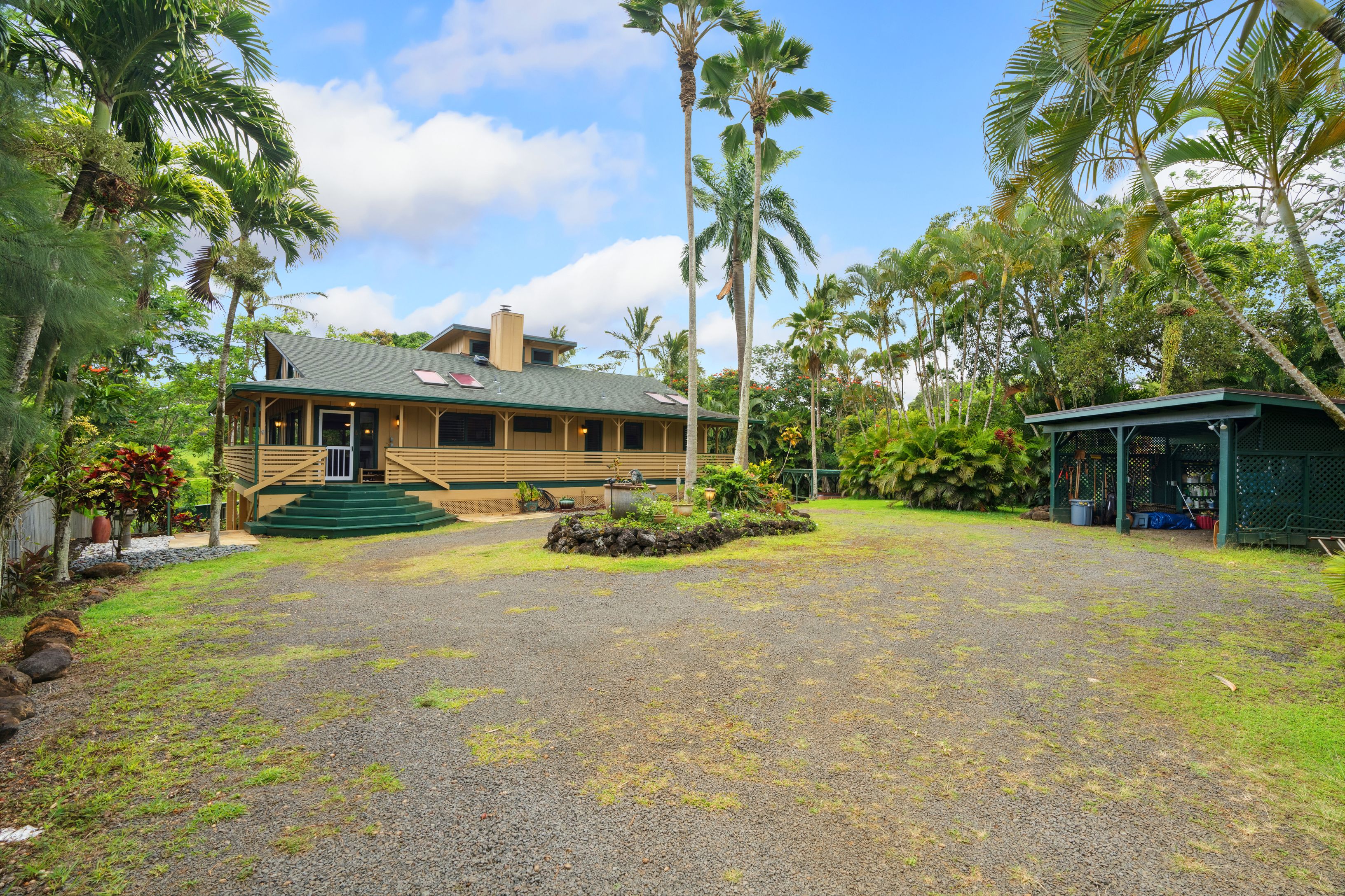 Long private gated driveway leads to the home with a large circular driveway, center fountain, 2 bay carport and your .85 acre tropical oasis