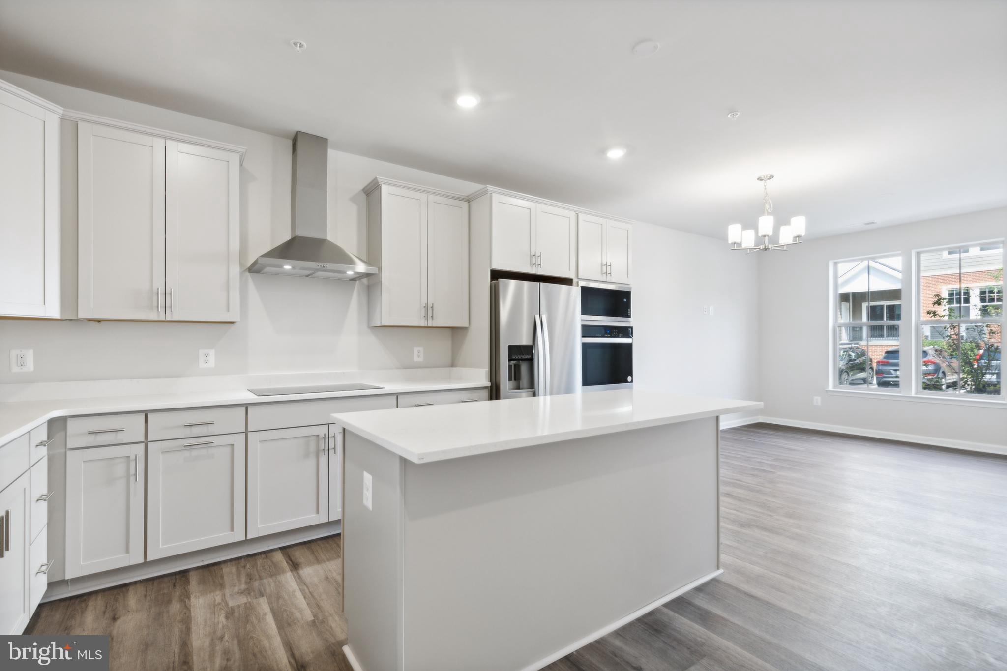 a kitchen with stainless steel appliances a sink stove and cabinets